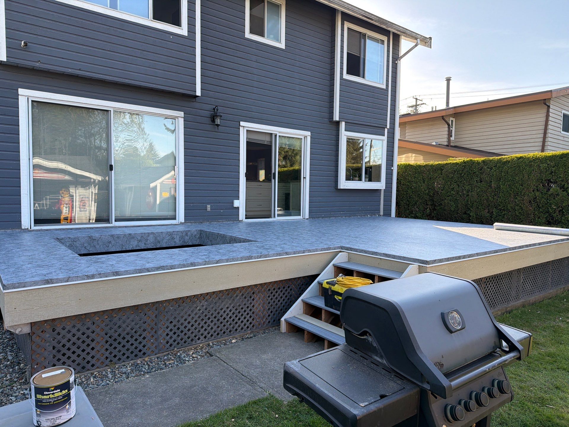 Wide shot of a finished balcony with vinyl decking membrane showing the complete waterproof surface and clean edge details