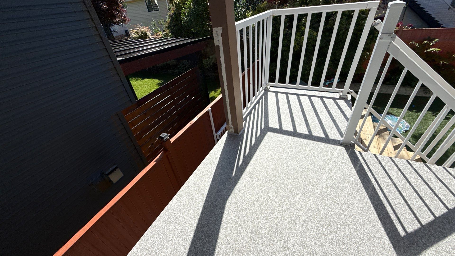 Valordek Flint Taupe vinyl decking membrane on a finished residential balcony with white railing