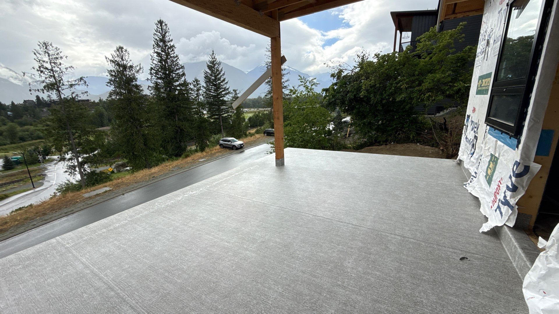 Valordek Smoke Grey vinyl deck membrane on a covered upper-level deck with a mountain view