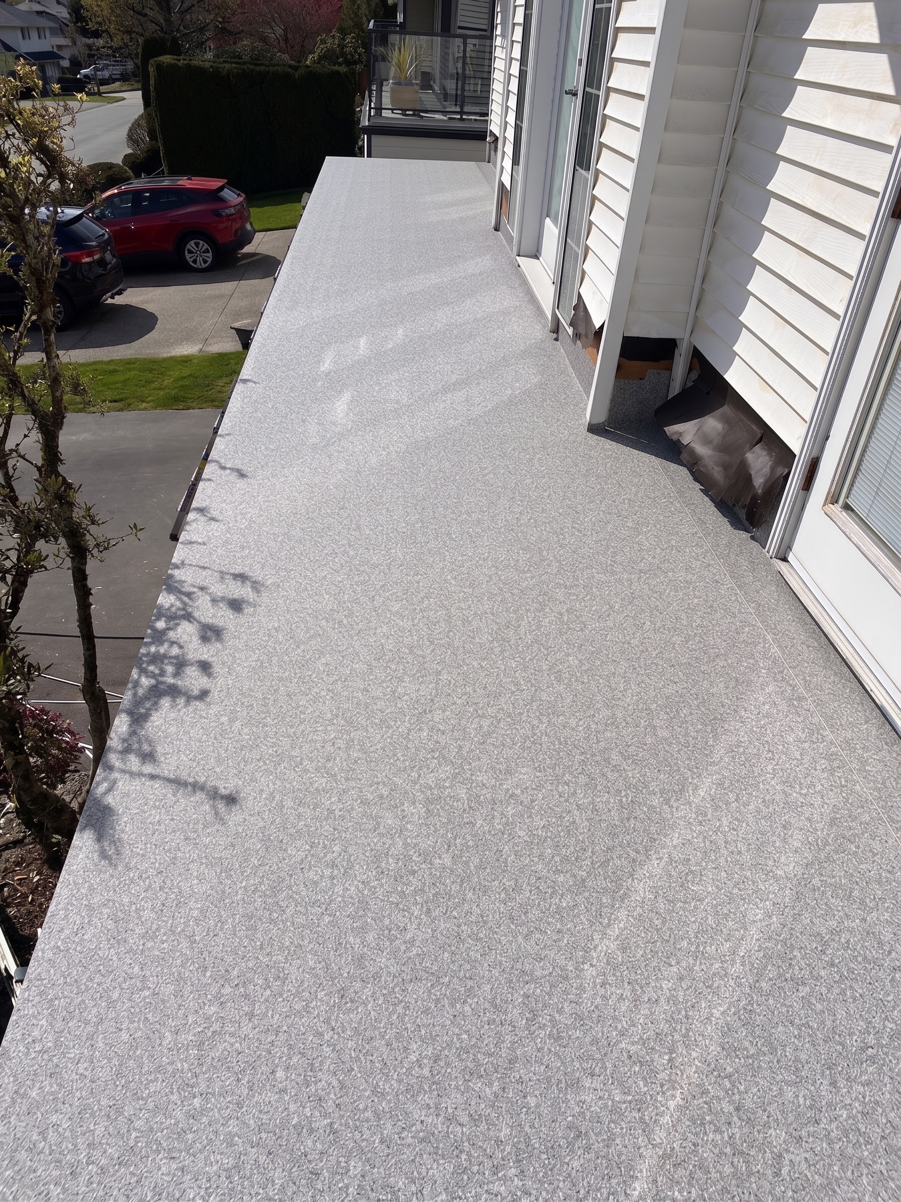 Valordek Flint Taupe vinyl deck membrane on a narrow balcony along a row of doors