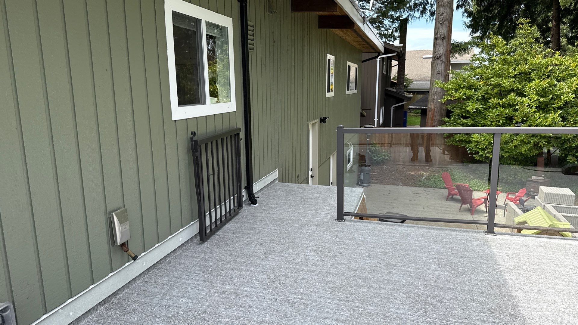 Valordek Smoke Grey vinyl decking membrane on an elevated balcony, turned up at the wall termination