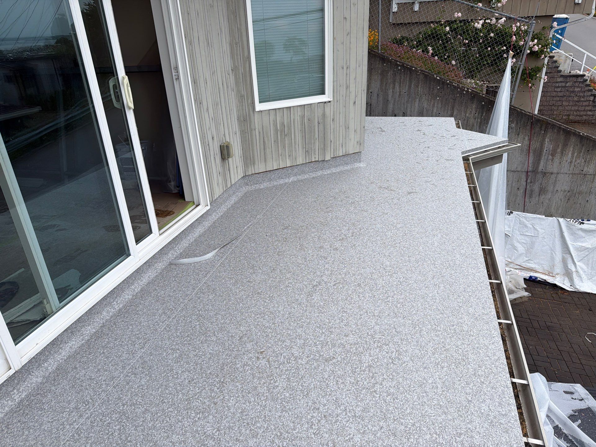 Valordek Flint Taupe vinyl decking membrane covering a large balcony deck over living space
